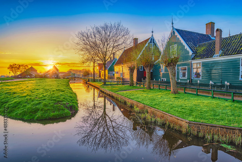 Fototapeta Naklejka Na Ścianę i Meble -  Amsterdam Netherlands, Sunrise landscape of Dutch Windmill and traditional house at Zaanse Schans Village