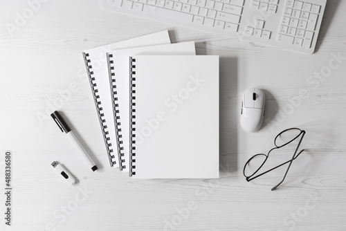 Three comb bound books on the table mockup
