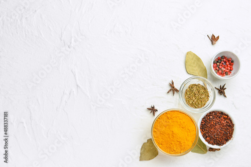 Fototapeta Naklejka Na Ścianę i Meble -  Bowls of aromatic spices on light background