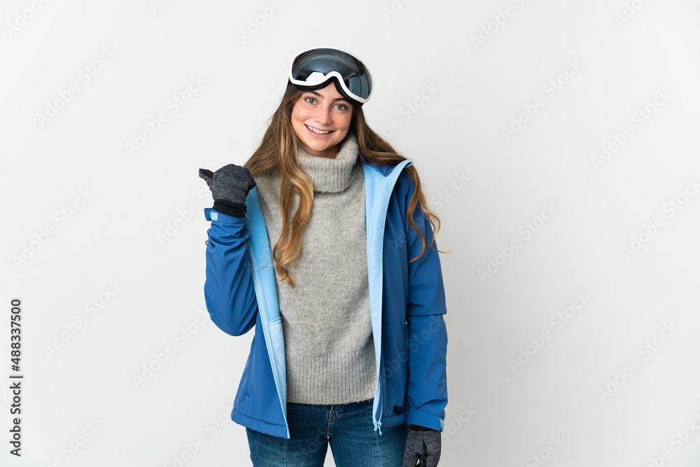 Skier girl with snowboarding glasses isolated on white background pointing to the side to present a product Skier girl with snowboarding glasses isolated on white background pointing to the side to present a product