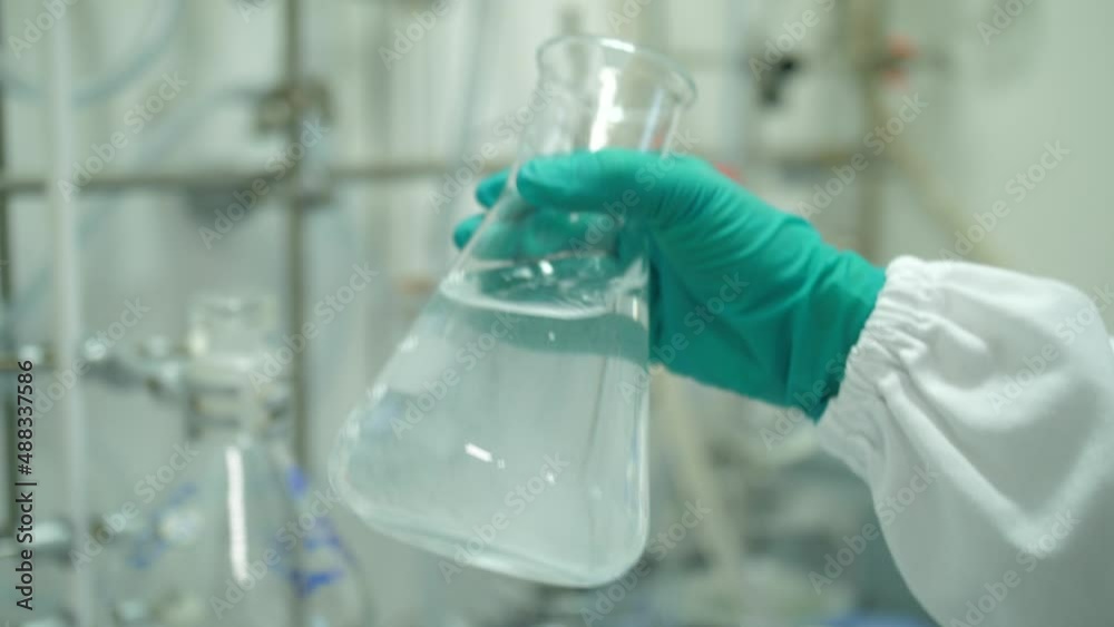 scientist hand shaking Erlenmeyer flask in laboratory slow motion 4k scientist hand shaking Erlenmeyer flask in laboratory slow motion 4k