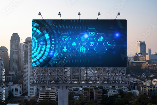 Hologram of Research and Development glowing icons on billboard. Sunset panoramic city view of Bangkok. Concept of innovative technologies to create new services and products in Southeast Asia.