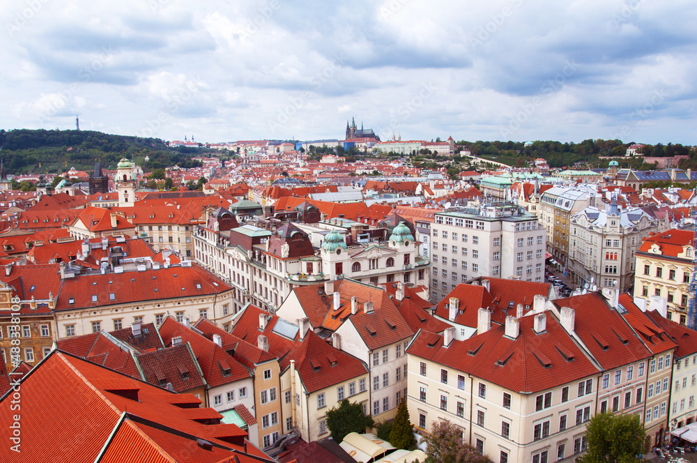 Obraz premium Top view to red roofs skyline of Prague city, Czech Republic. Aerial view of Prague city with terracotta roof tiles, Prague, Czechia. Old Town architecture with roofs in Prague