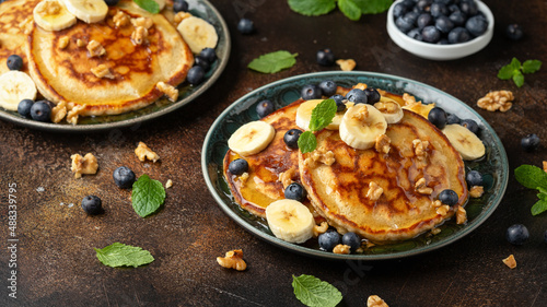 American pancakes with banana, blueberry, walnut and honey. Healthy morning breakfast