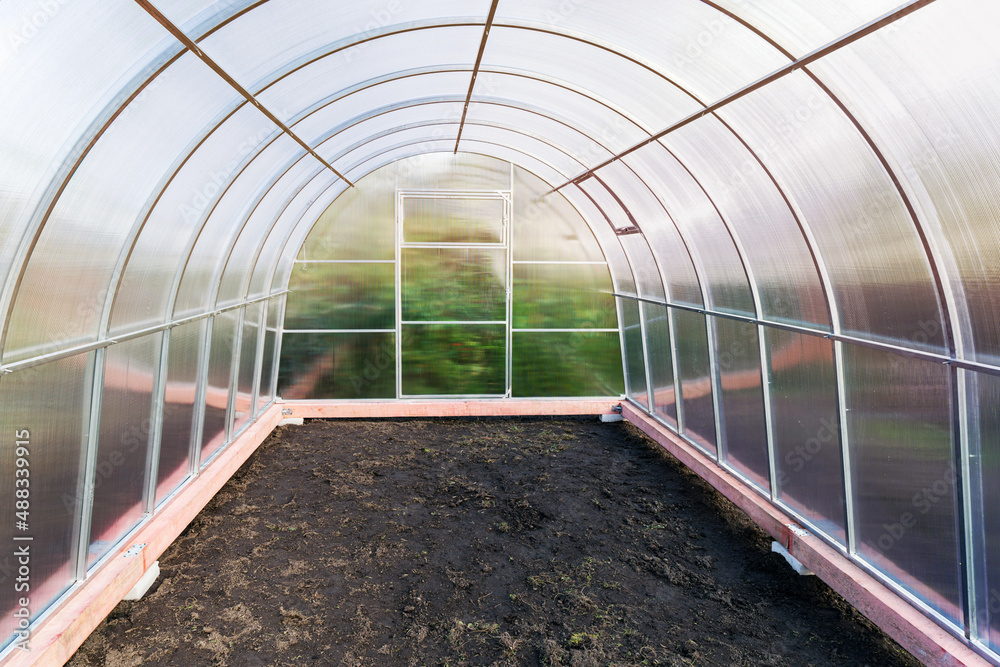 Greenhouse made of polycarbonate on a metal frame, inside view. Greenhouse made of polycarbonate on a metal frame, inside view.
