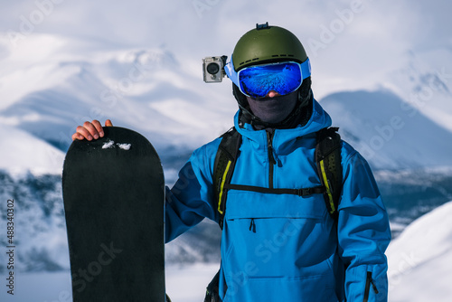 Man in the mountains with a snowboard