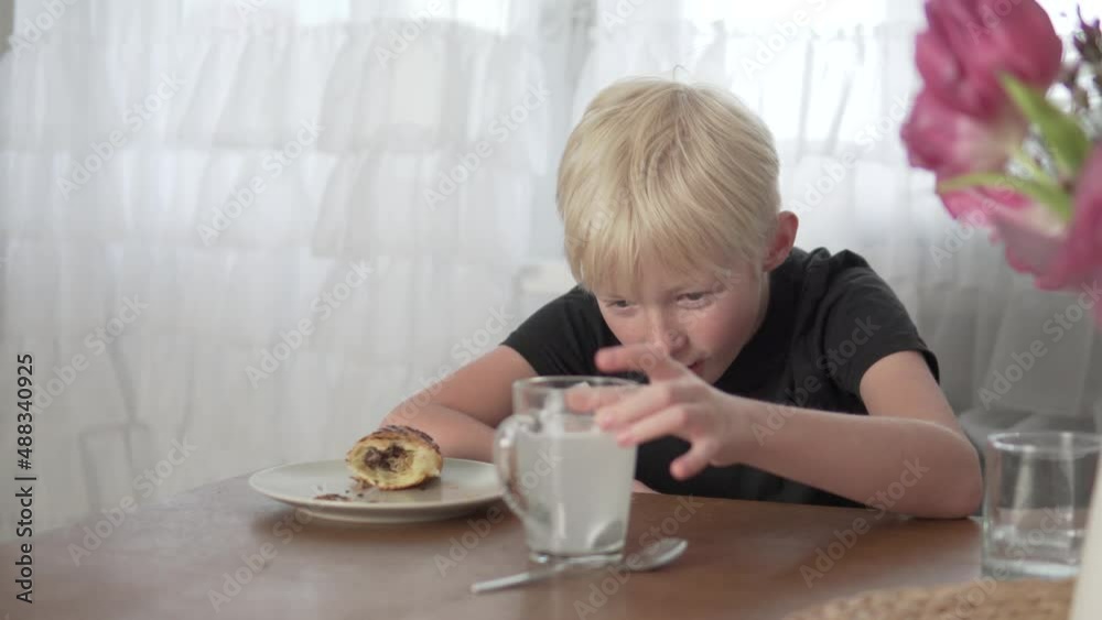 The boy put an orthopedic denture in a glass with a cleaning solution before eating at home. The boy put an orthopedic denture in a glass with a cleaning solution before eating at home.