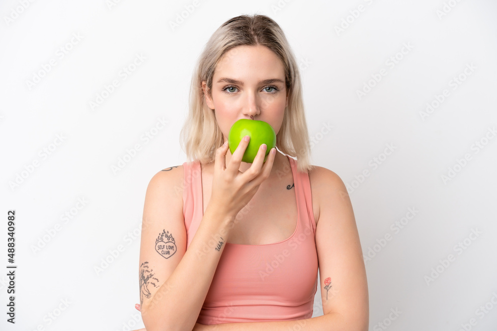 Young caucasian woman isolated on white background eating an apple Young caucasian woman isolated on white background eating an apple