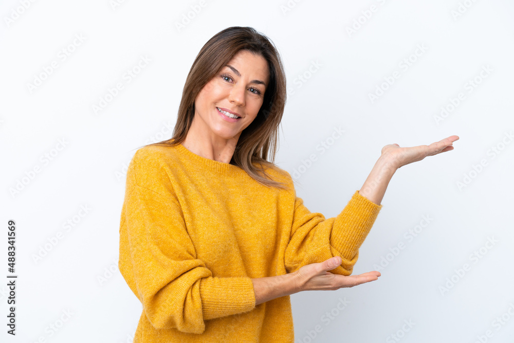 Middle age caucasian woman isolated on white background extending hands to the side for inviting to come Middle age caucasian woman isolated on white background extending hands to the side for inviting to come