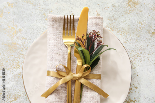 Stylish simple table setting and flowers on light background