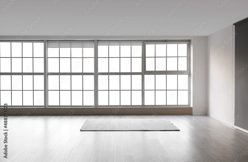 View of empty room with carpet and windows