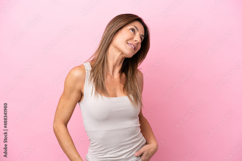 Middle age caucasian woman isolated on pink background thinking an idea while looking up Middle age caucasian woman isolated on pink background thinking an idea while looking up