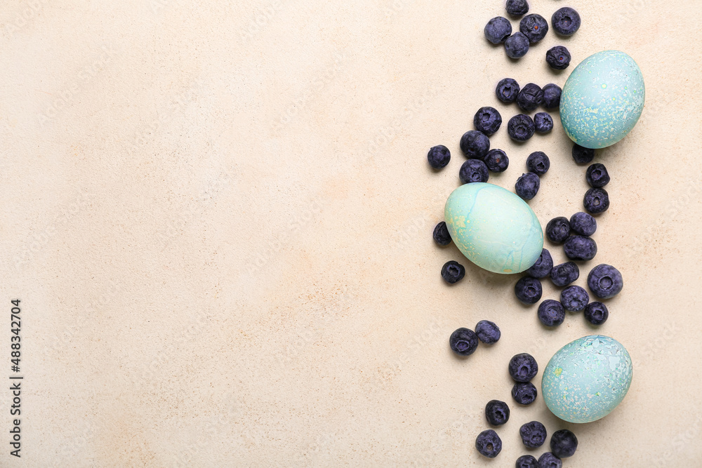 Beautiful Easter eggs and blueberry on light background Beautiful Easter eggs and blueberry on light background