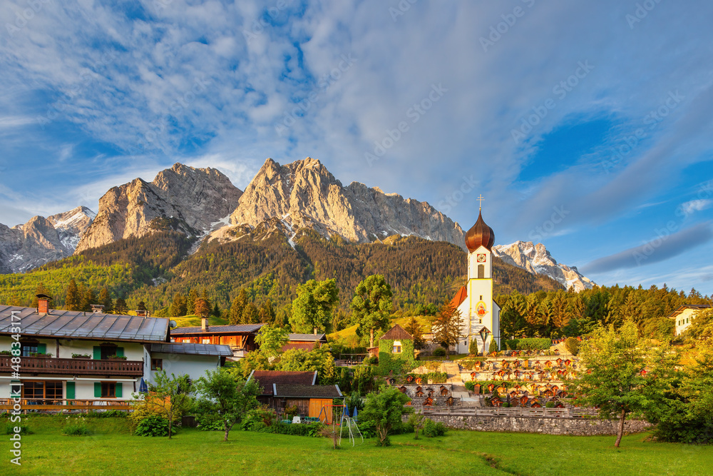 Zugspitze peak and Alps mountain range with small church, Garmisch Partenkirchen, Germany