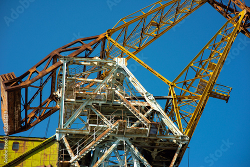 Shipbuilding crane against the blue sky, close-up