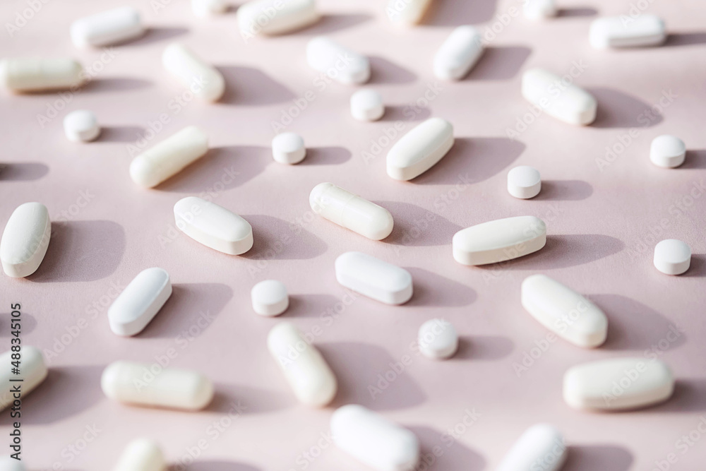Different pills, vitamin capsules on pastel pink background. Dietary supplement supports for health. - obrazy, fototapety, plakaty 