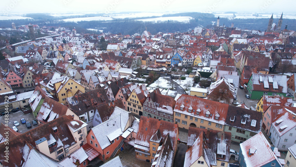 Fototapeta premium Aerial View: Rooftops with snow in Rothenburg ob der Tauber, Bavaria. Rothenburg is one of the famous tourist attractions in Germany. It’s well known for its well-preserved medieval old town.