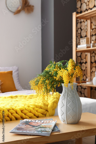 Vase with mimosa flowers an...