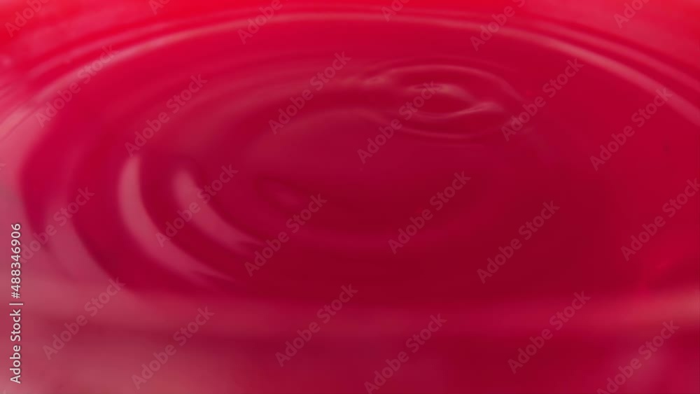 A drop of juice falls on the surface of the juice of Sicilian oranges. Slow motion. A drop of juice falls on the surface of the juice of Sicilian oranges. Slow motion.