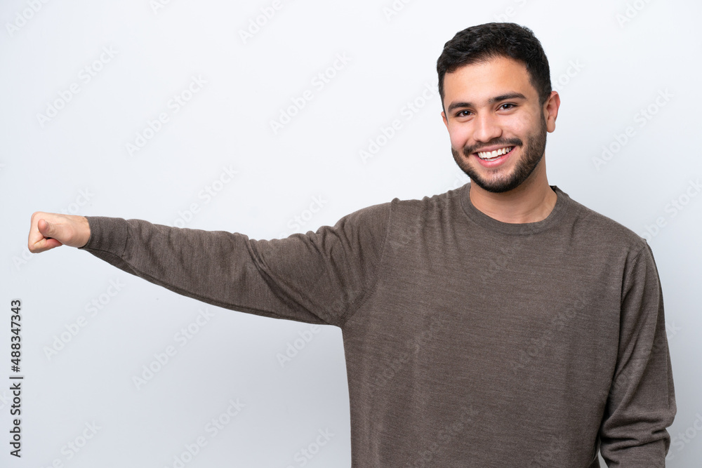 Young Brazilian man isolated on white background giving a thumbs up gesture Young Brazilian man isolated on white background giving a thumbs up gesture