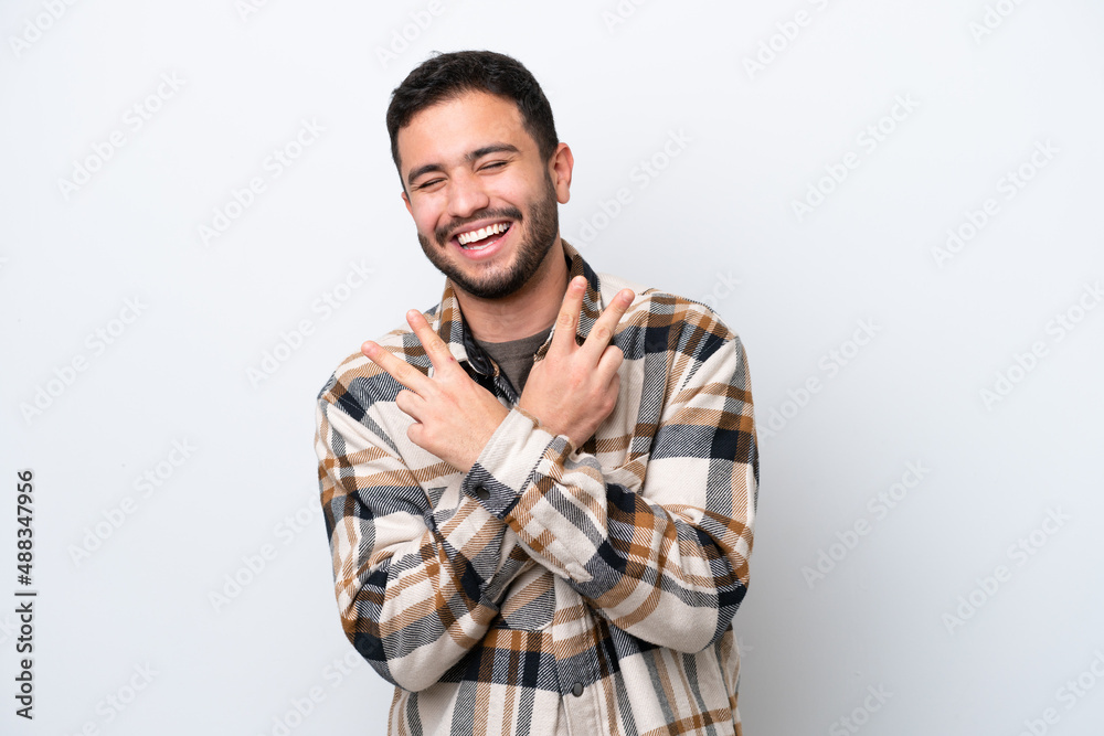 Young Brazilian man isolated on white background smiling and showing victory sign Young Brazilian man isolated on white background smiling and showing victory sign