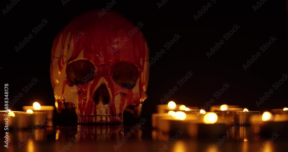 Blood stained skull against dark background closeup Blood stained skull against dark background closeup