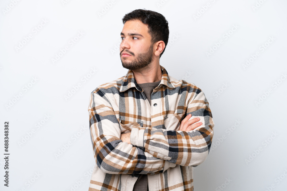 Young Brazilian man isolated on white background keeping the arms crossed Young Brazilian man isolated on white background keeping the arms crossed