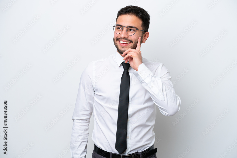 Business Brazilian man isolated on white background thinking an idea while looking up Business Brazilian man isolated on white background thinking an idea while looking up