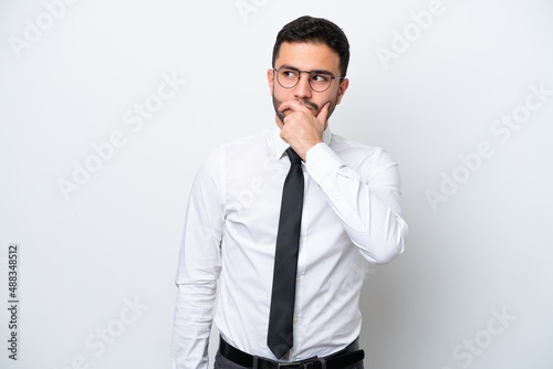 Business Brazilian man isolated on white background having doubts and with confuse face expression