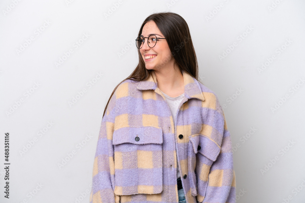 Young girl isolated on white background looking to the side and smiling Young girl isolated on white background looking to the side and smiling