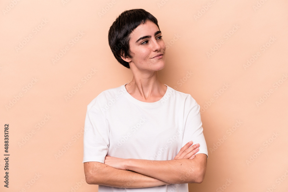 Young caucasian woman isolated on beige background dreaming of achieving goals and purposes Young caucasian woman isolated on beige background dreaming of achieving goals and purposes