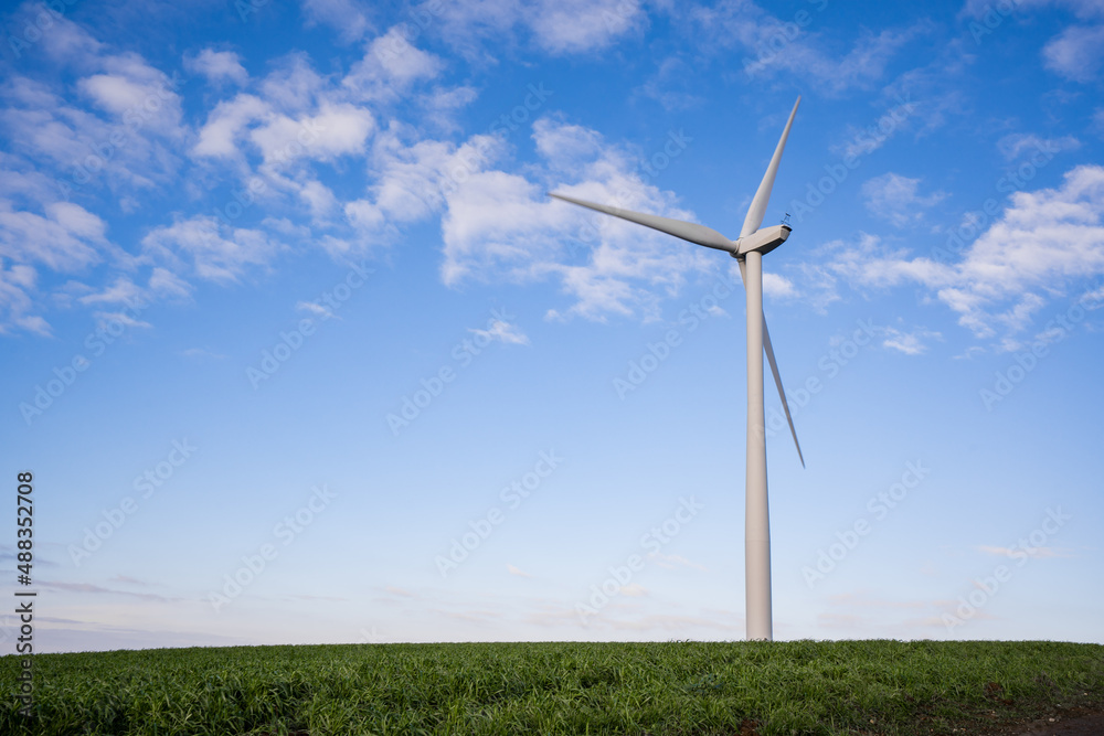 Wind turbine generating renewable energy on a clear windy day Wind turbine generating renewable energy on a clear windy day