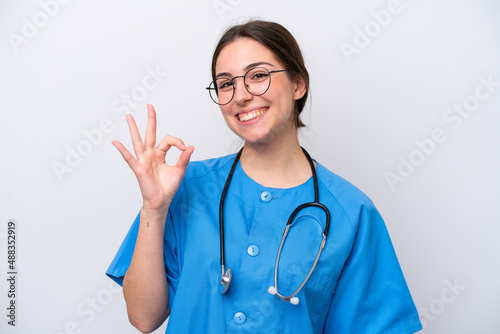 surgeon doctor woman holding tools isolated on white background showing ok sign with fingers © luismolinero