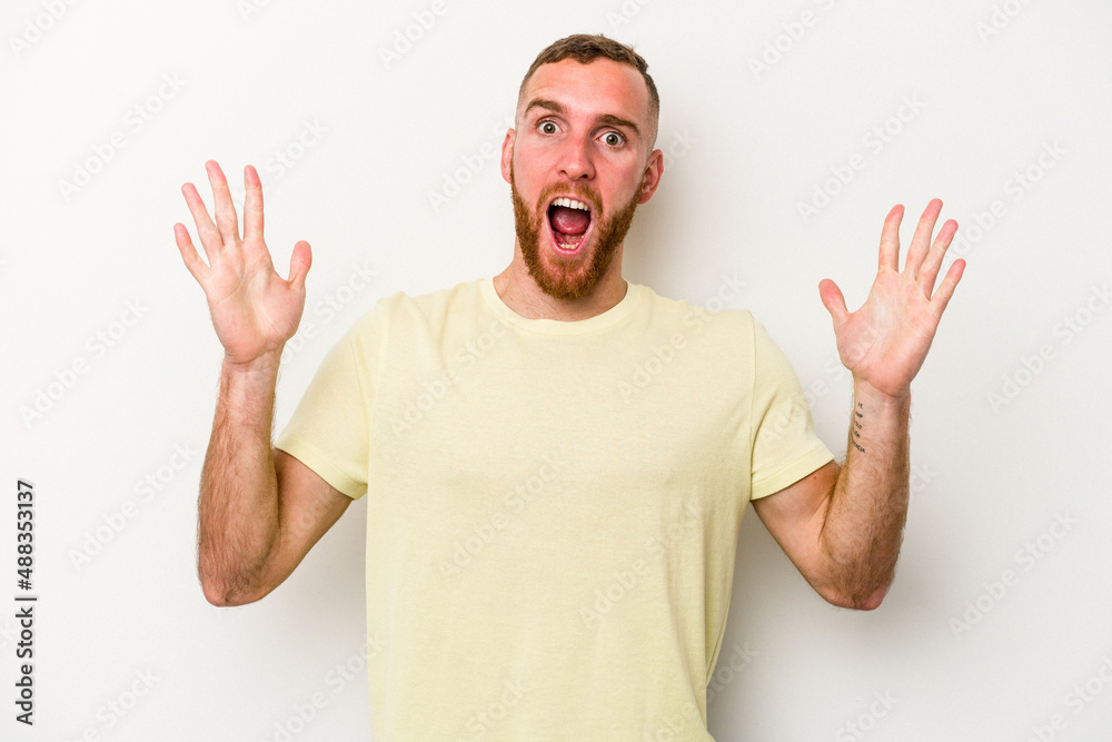 Young caucasian man isolated on white background celebrating a victory or success, he is surprised and shocked. Young caucasian man isolated on white background celebrating a victory or success, he is surprised and shocked.