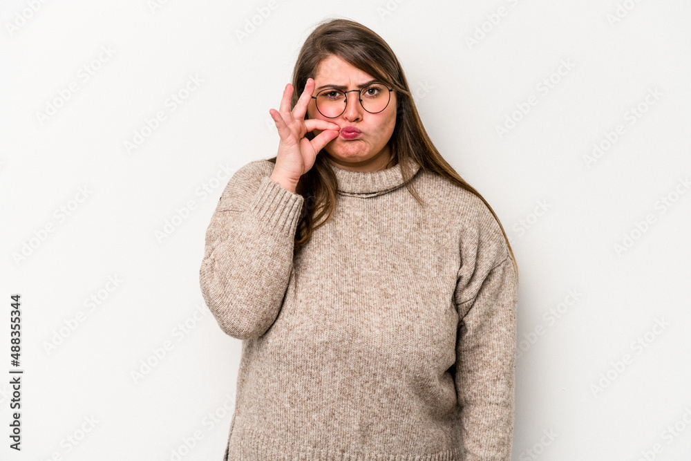 Young caucasian overweight woman isolated on white background with fingers on lips keeping a secret. Young caucasian overweight woman isolated on white background with fingers on lips keeping a secret.