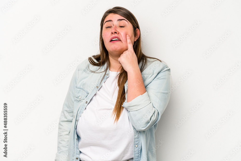 Young caucasian overweight woman isolated on white background crying, unhappy with something, agony and confusion concept.
