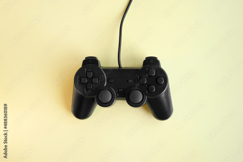 One joystick gaming controller on yellow background.