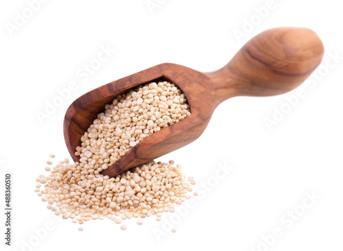 White quinoa seeds in wooden scoop, isolated on white background. Pile of raw kinwa.