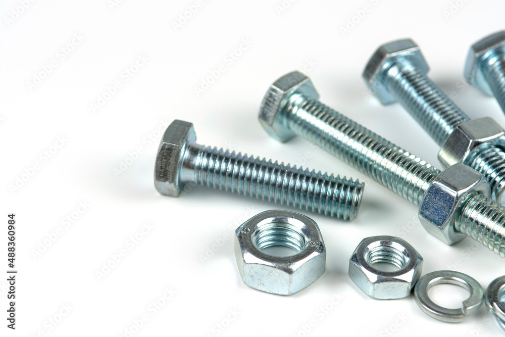 metal bolts and nuts with round washers close-up on a white background. copy space metal bolts and nuts with round washers close-up on a white background. copy space