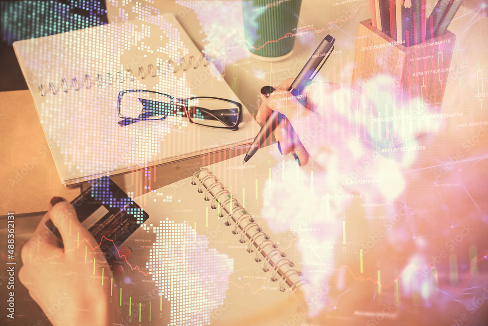 Multi exposure of woman on-line shopping holding a credit card and financial graph drawing. Stock market E-commerce concept. Multi exposure of woman on-line shopping holding a credit card and financial graph drawing. Stock market E-commerce concept.