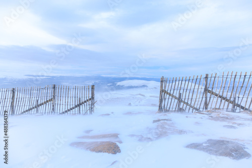 A scenic view of a snow storm in a Scottish mountain with high wind, snow and blizard conditions	
