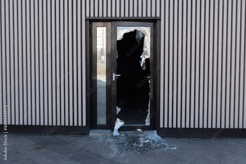 Broken glass door in shopping mall. Vandalism, burglary concept. Insurance concept. - obrazy, fototapety, plakaty 