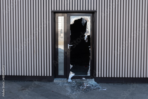 Broken glass door in shopping mall. Vandalism, burglary concept. Insurance concept. photo