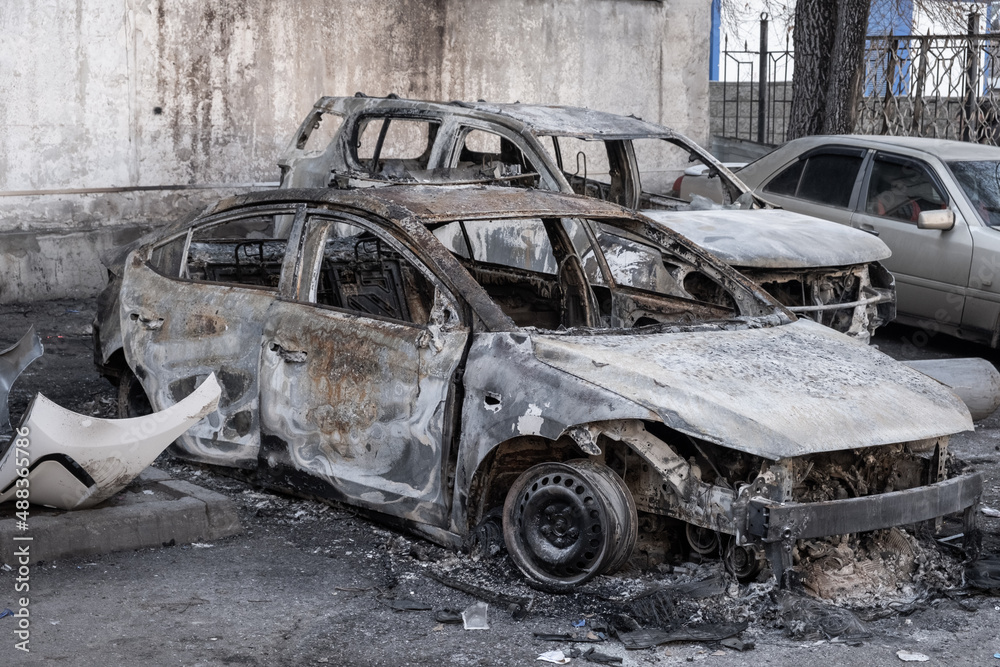 Closeup of burnt-out car completely destroyed due to arson during demonstrations. Vandalism concept. Closeup of burnt-out car completely destroyed due to arson during demonstrations. Vandalism concept.