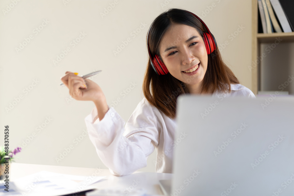 Woman working on laptop at home and chatting with friends over video call. Woman working on laptop at home and chatting with friends over video call.