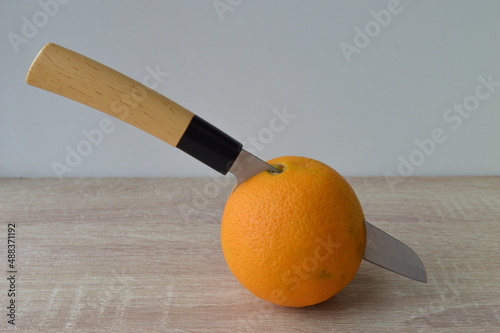 cutting organic oranges in half to make a healthy orange juice drink	
