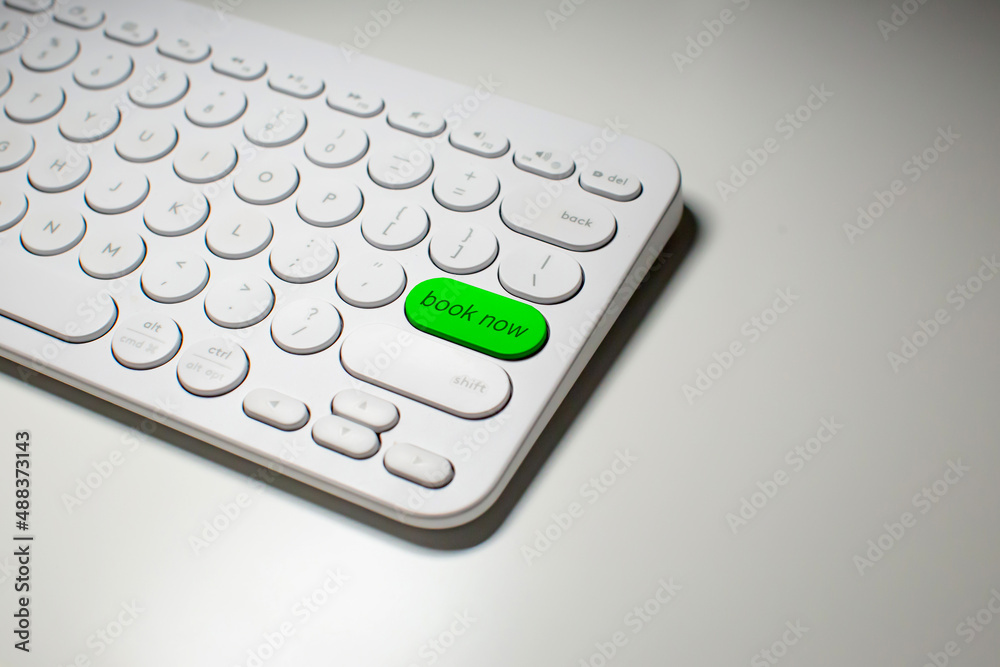 Close up of a Book Now button on a keyboard.
