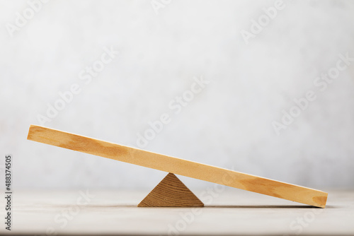 Foto Wooden swing or scales on an abstract background, a template for the designer