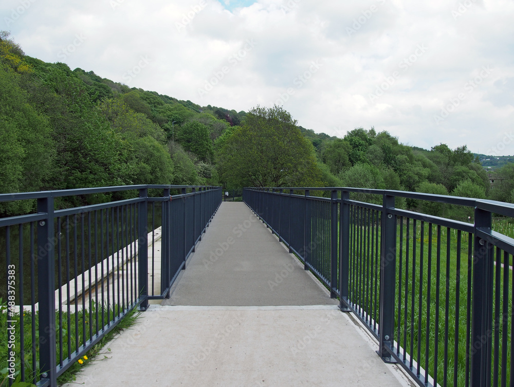 raised pedestrian footbridge over the brearley fields canal spillway next to the river calder in west yorkshire raised pedestrian footbridge over the brearley fields canal spillway next to the river calder in west yorkshire