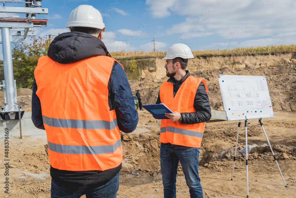 Two engineer electricians check the substation construction process Two engineer electricians check the substation construction process